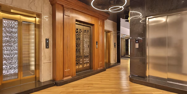 Modern elevator cabin with sleek false ceiling and stylish flooring design.