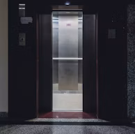 An elevator with a door open in a building